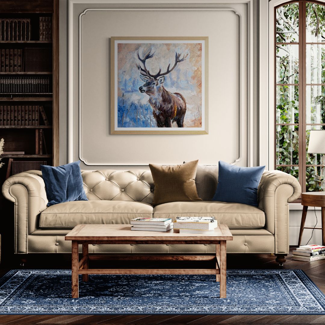Living room with beige sofa, wooden coffee table, and stag print with neutral frame on wall