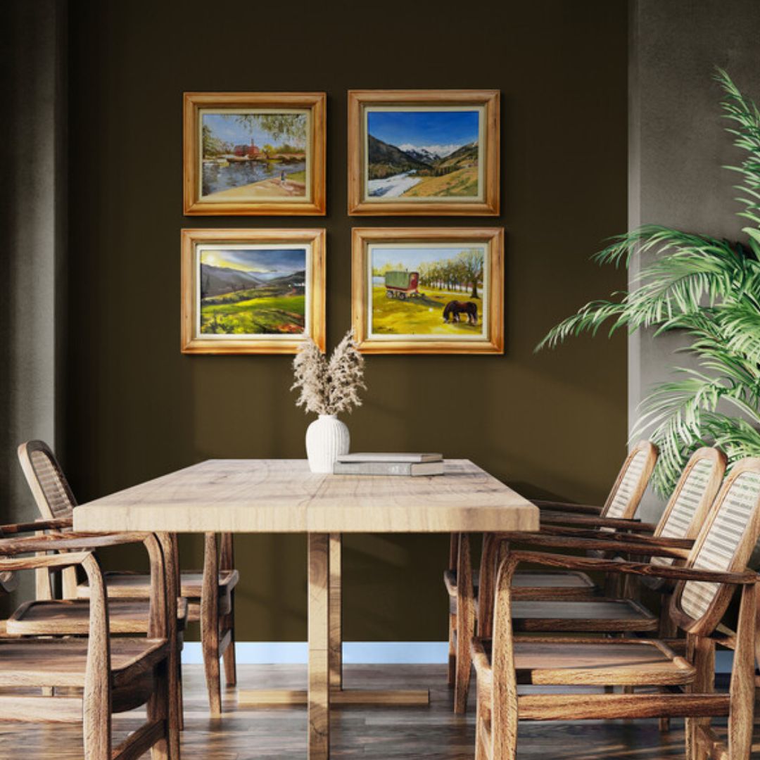 Dining room interior featuring four original oil paintings from Lorraine Field’s Painted on Location collection. Impressionistic plein air landscapes painted outdoors