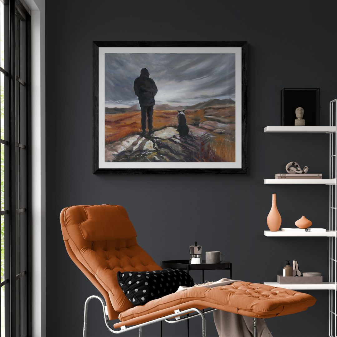 Living room with orange recliner, dark gray wall, and framed artwork of a dog and his master