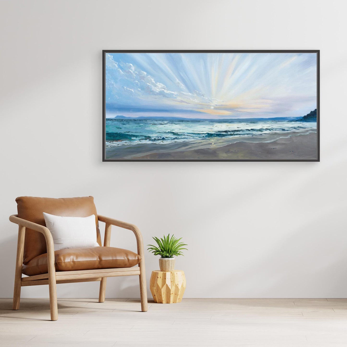 Large panoramic beach canvas artwork displayed above a chair in a calm neutral interior inspired by Cornwall’s coastline.