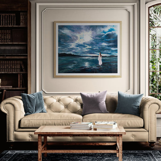 Living room with beige sofa, wooden coffee table, and framed artwork of a dramatic seascape with a beautiful woman.