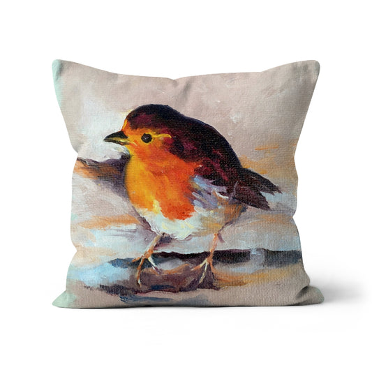 Vibrant red-breasted robin cushion on a neutral blush background. Heartwarming home accessory evoking memory, comfort, and seasonal charm.