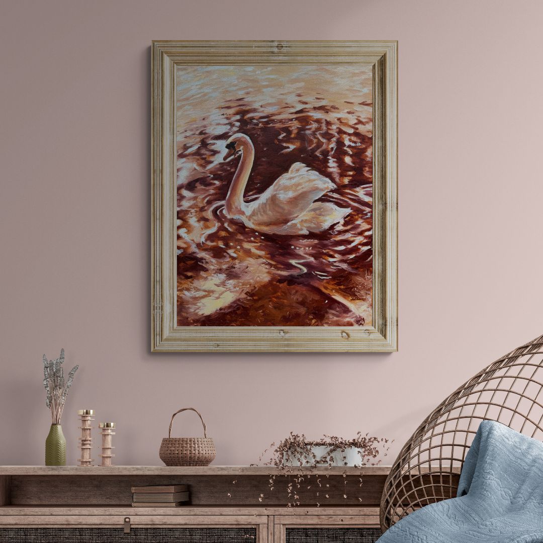 Framed original oil painting of a swan on the River Avon in Stratford-upon-Avon displayed in a soft neutral interior.