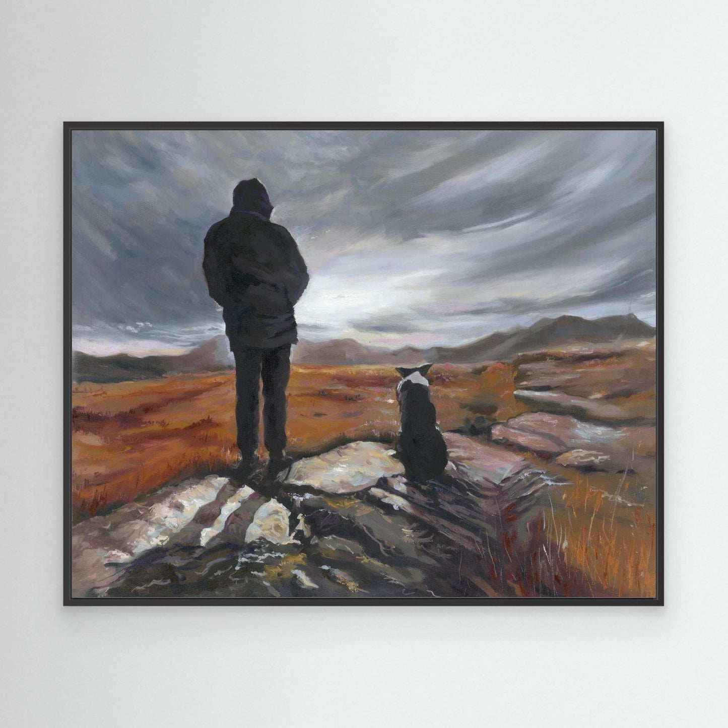 black framed “Man and His Border” canvas art