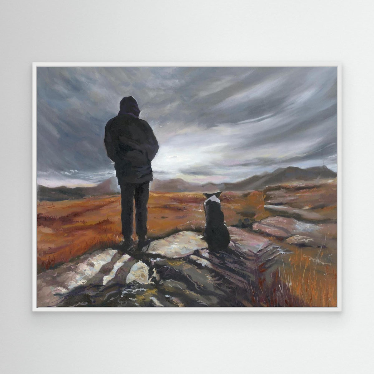 Man and His Border canvas print in a white frame, depicting a man and his Border Collie beneath a sweeping grey sky.