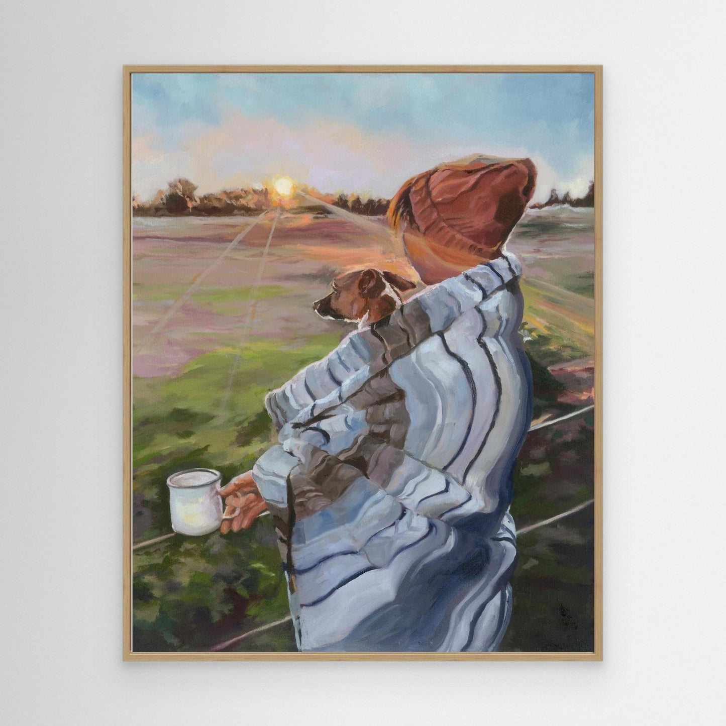 Sunrise with the Pup canvas print in an oak frame, a nostalgic fine art piece showing a sunrise walk with a dog wrapped in a blanket.