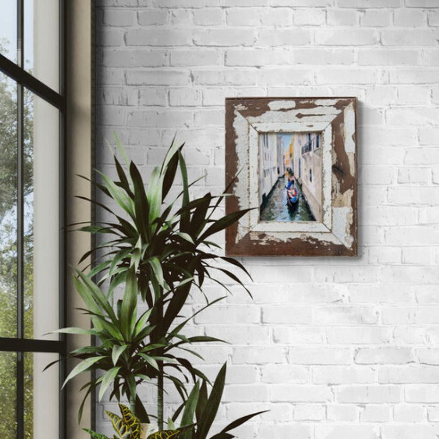 Original Venice gondola oil painting by Lorraine Field Art displayed on a white brick wall in a bright contemporary room