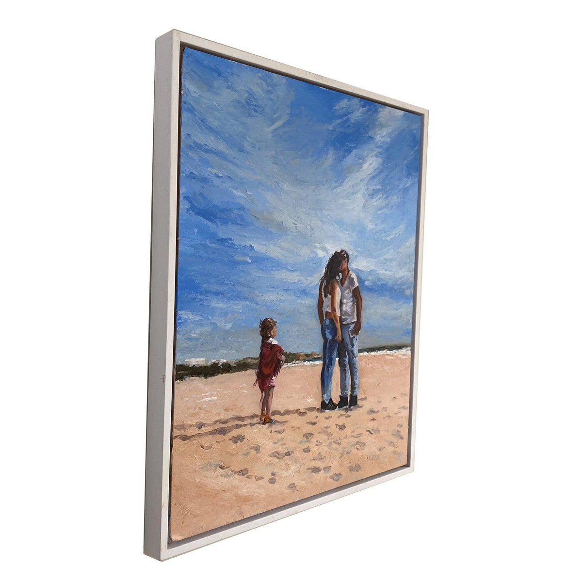 Mama original beach scene oil painting viewed at an angle, showing the depth of its white wooden float frame.