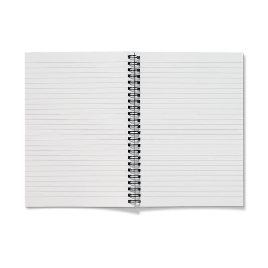 Open spiral-bound notebook showing ruled pages and inner pocket, ready for journaling, notes, or quiet reflection.