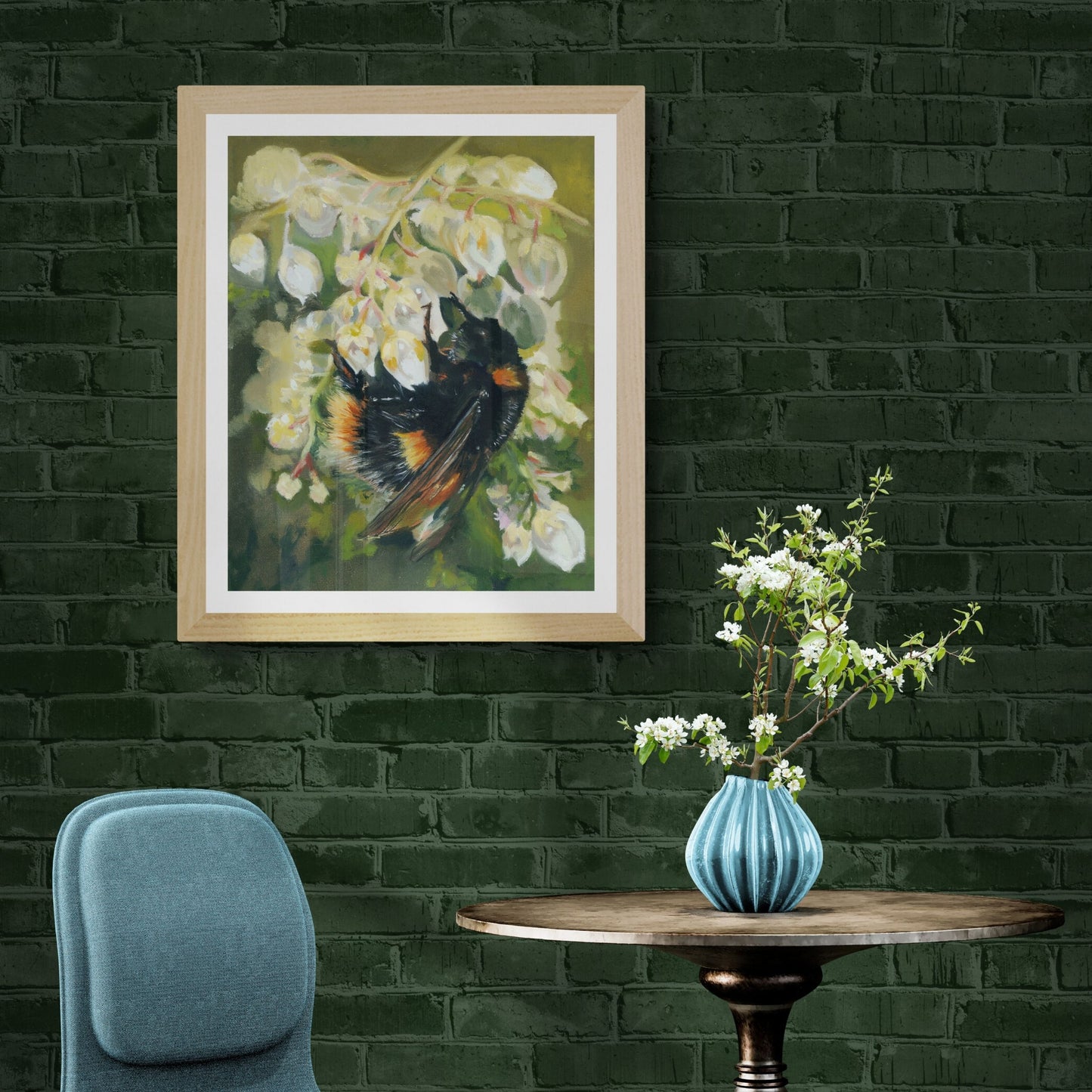 Bumble bee print in natural frame displayed on dark green wall