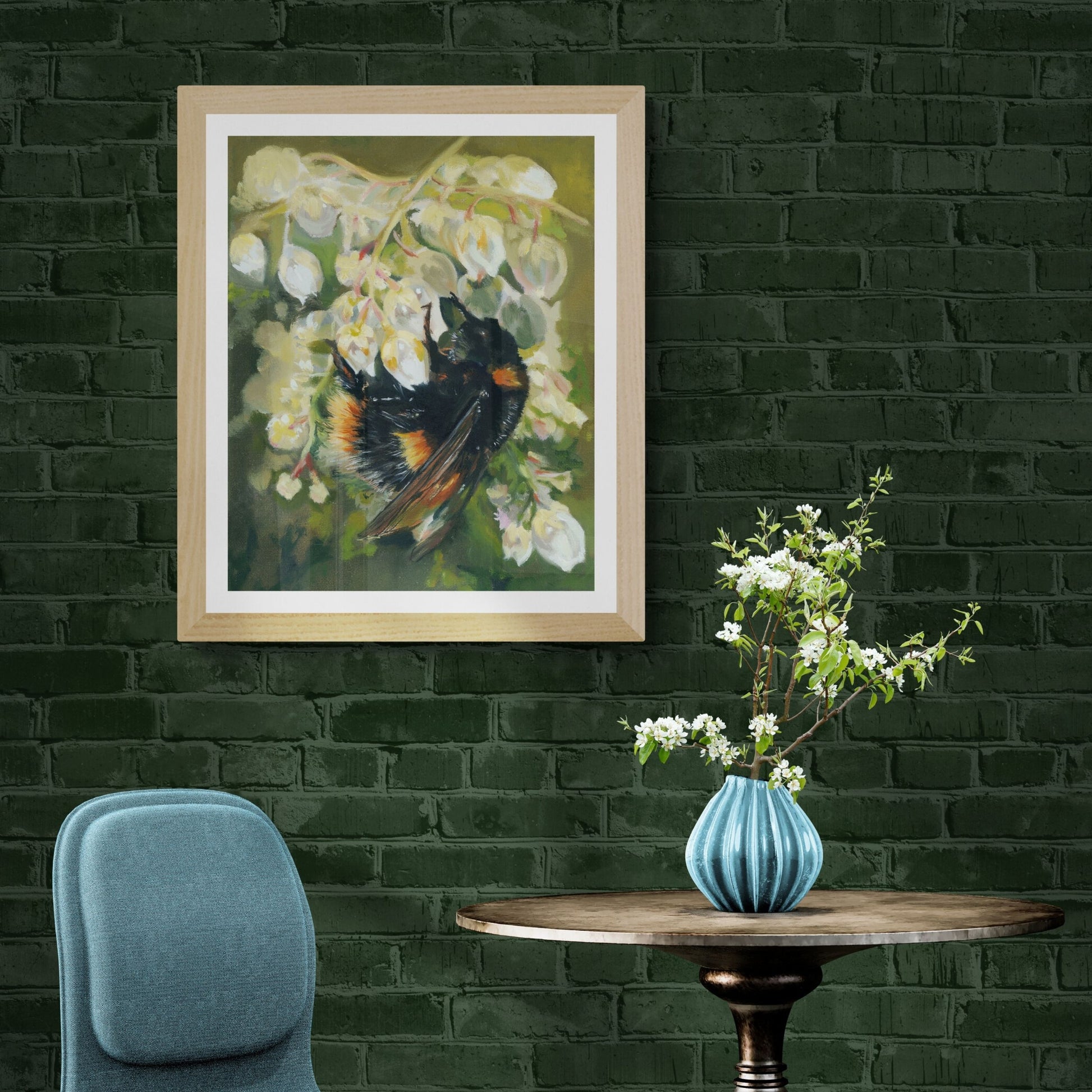 Bumble bee print in natural frame displayed on dark green wall