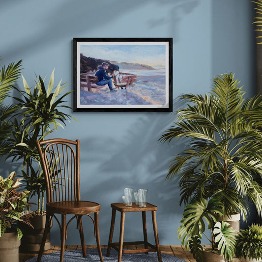 Framed artwork of a man and his dog hanging on a blue wall with plants and furniture below.