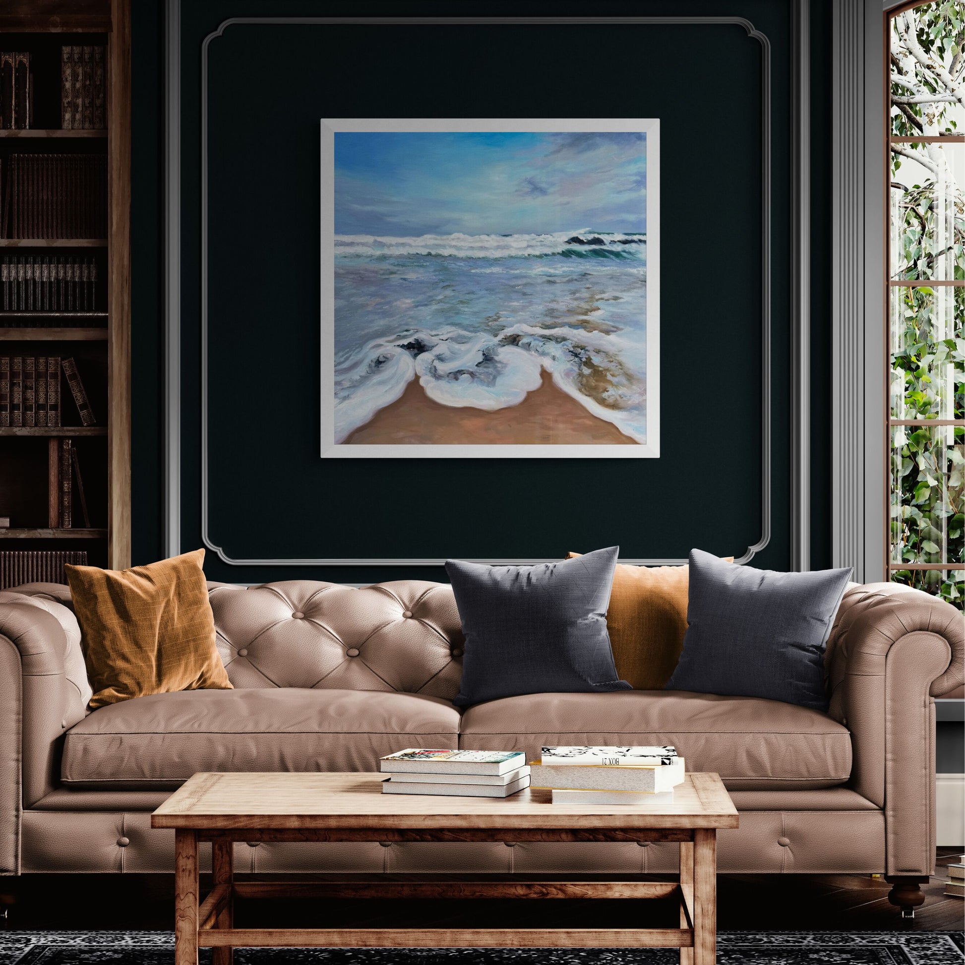Frothy seas art print in white frame option on dark blue wass above beige sofa