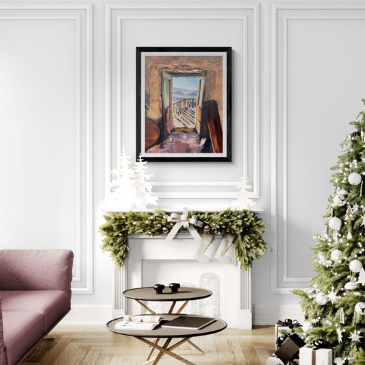 Living room with a Christmas tree, pink sofa, and framed rustic doorway artwork on a white wall.