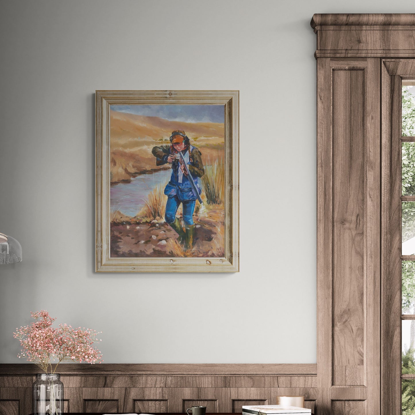 Framed artwork of a young girl shooting clays in a natural countryside setting 