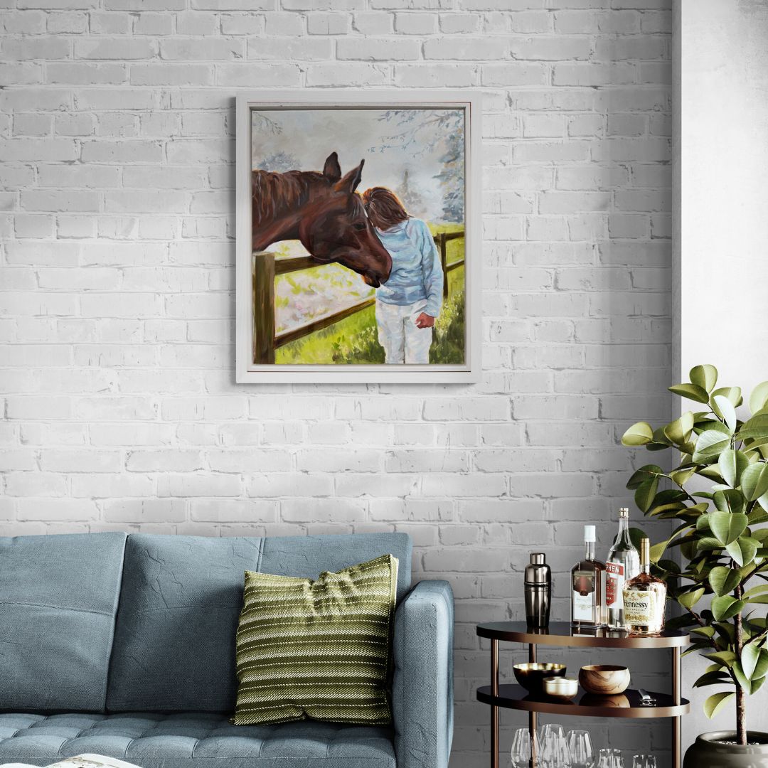 He Knows Original oil painting of a horse and owner holding their heads together in an emotional gesture, in white frame on a white brick wall