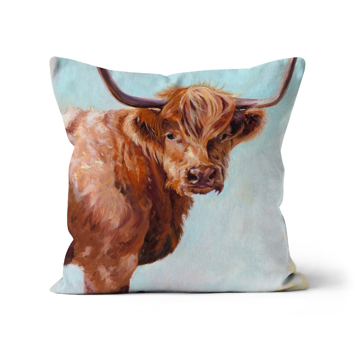 Cushion with a design of a highland cow on a light blue background