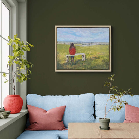 Original oil painting of a woman sitting alone on a bench overlooking rolling countryside beneath a blue sky, by British artist Lorraine Field.