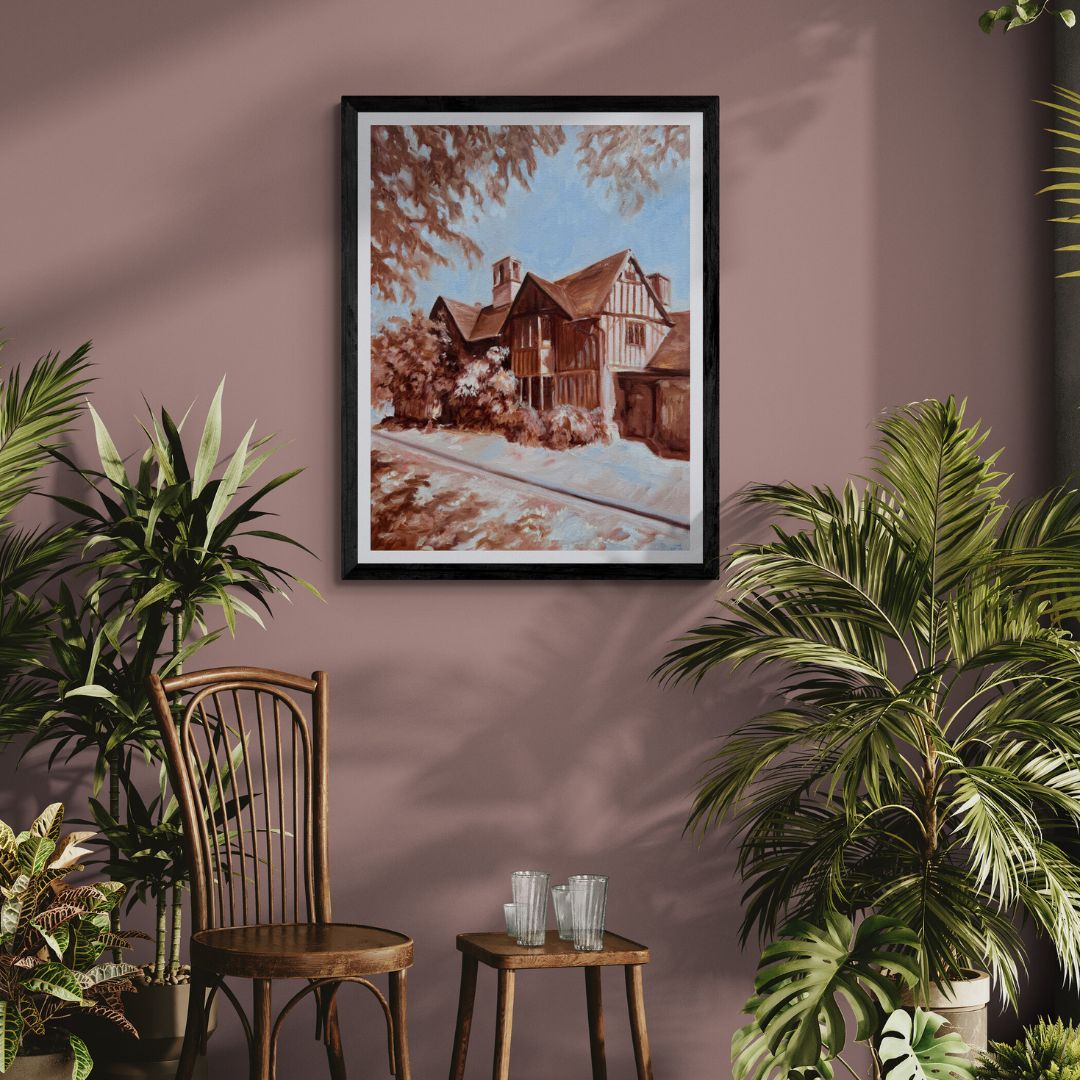 Hall’s Croft fine art print in a black frame displayed on a dusky pink wall with plants and vintage wooden chairs, inspired by Shakespeare’s daughter’s historic Stratford-upon-Avon home.
