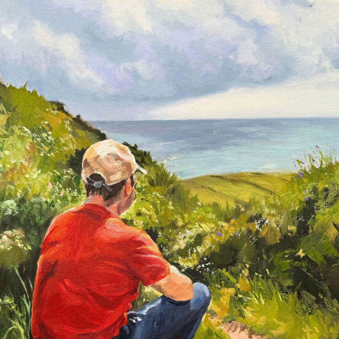 Close-up of Just taking it in original oil painting, showing textured brushwork across the seated figure, green cliffs and blue-grey sea.
