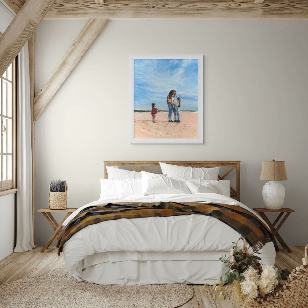 Bedroom art with a framed oil painting of a kissing couple and a little girl on a beach.