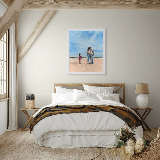 Bedroom art with a framed oil painting of a kissing couple and a little girl on a beach.