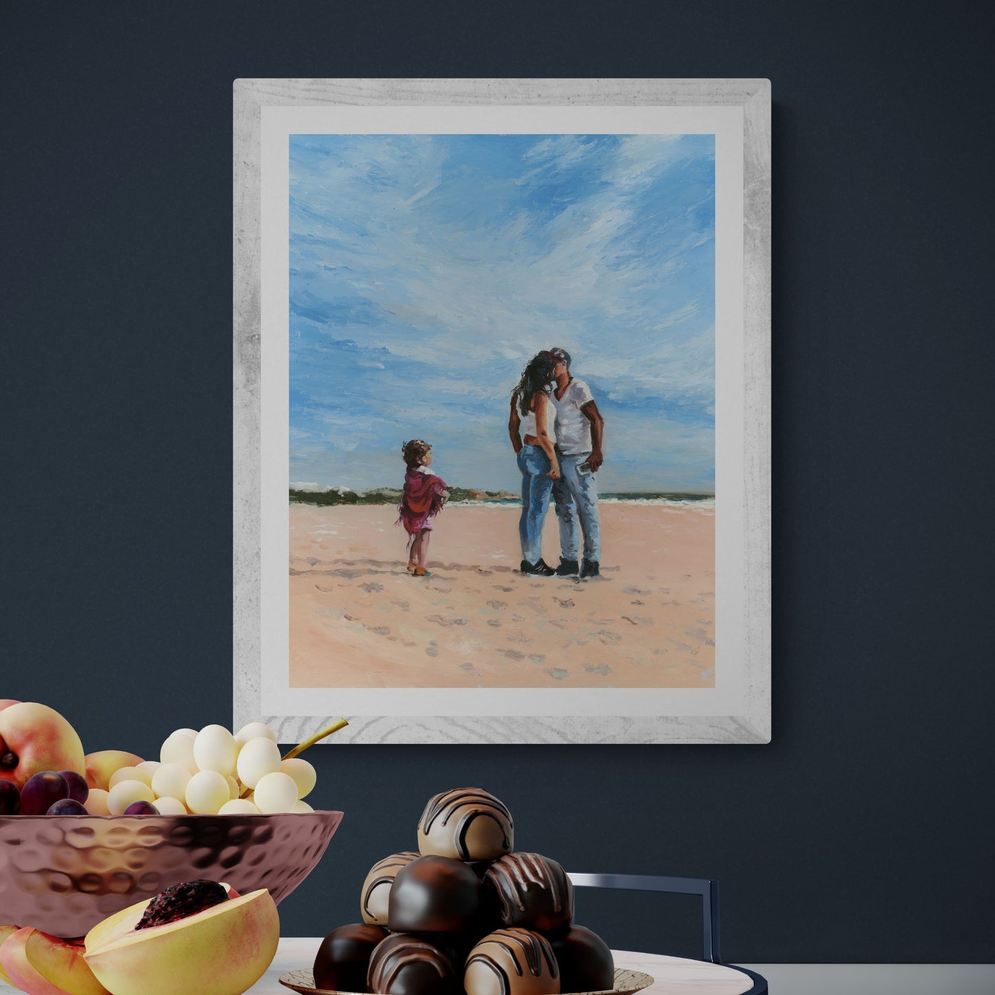 'Mama' art print in a white frame option, showing a couple kissing with a child wrapped in a cerise shawl watching them.