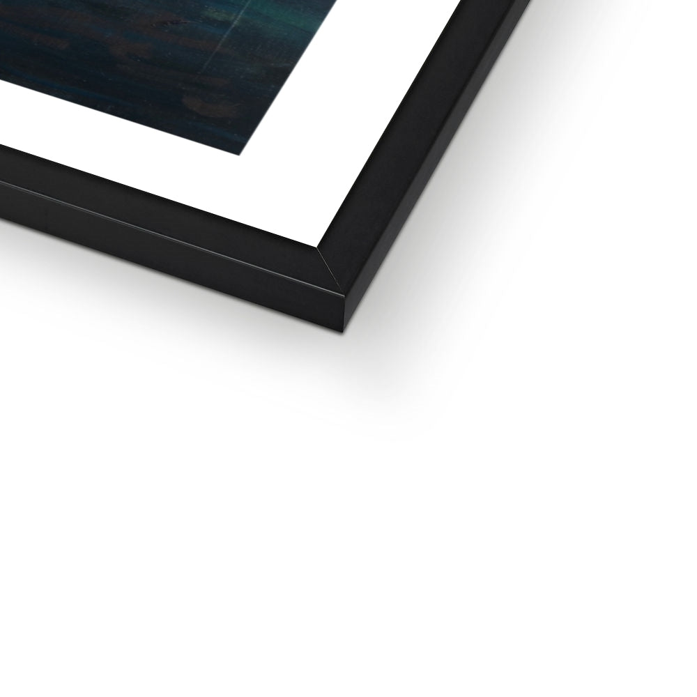 Close-up of a black framed art print on a white background
