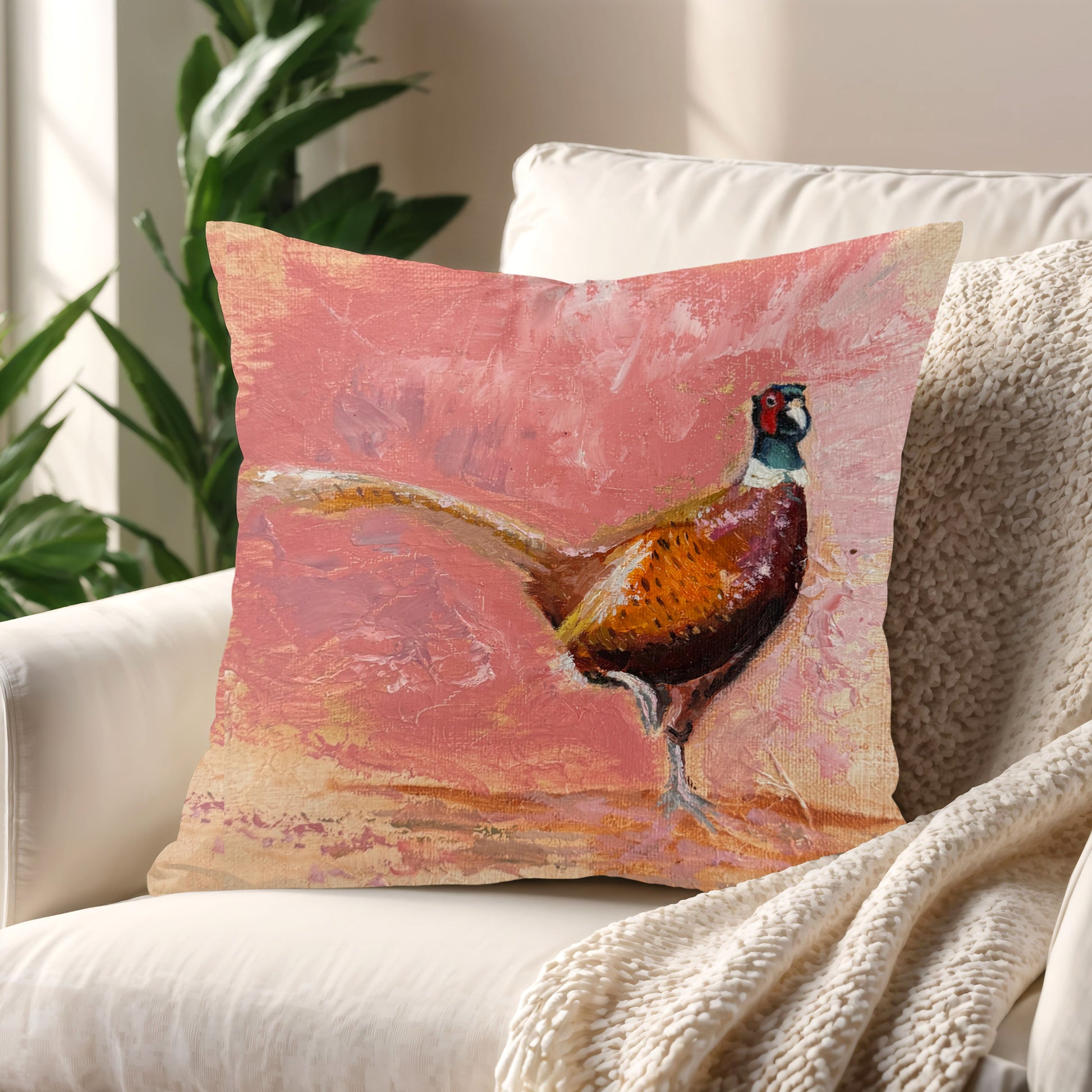 Playful Pheasant Cushion styled on a cosy armchair in a sunlit living room corner.