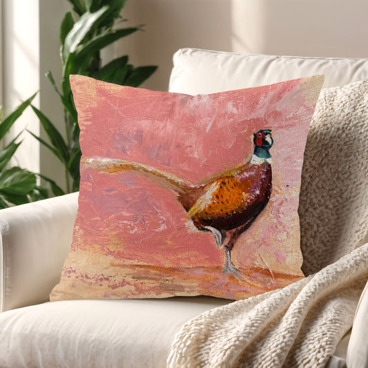 Playful Pheasant Cushion styled on a cosy armchair in a sunlit living room corner.
