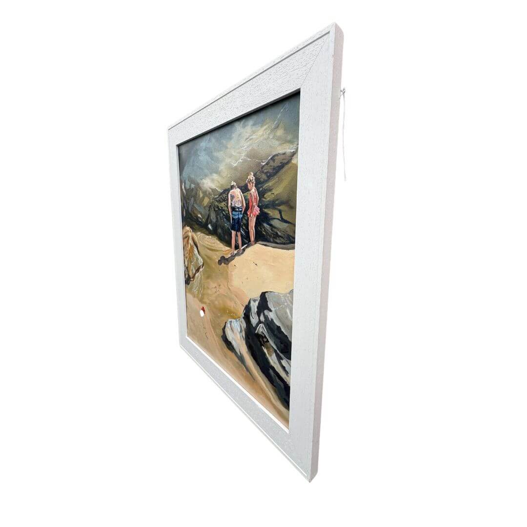 Angled view of the framed Rockpool Explorers oil painting, featuring two children beside the rocks at St Agnes beach.