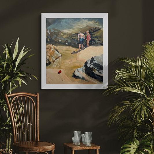 Oil painting Rockpool Explorers in a white wooden frame, hanging on a dark wall with wooden chair and green plants