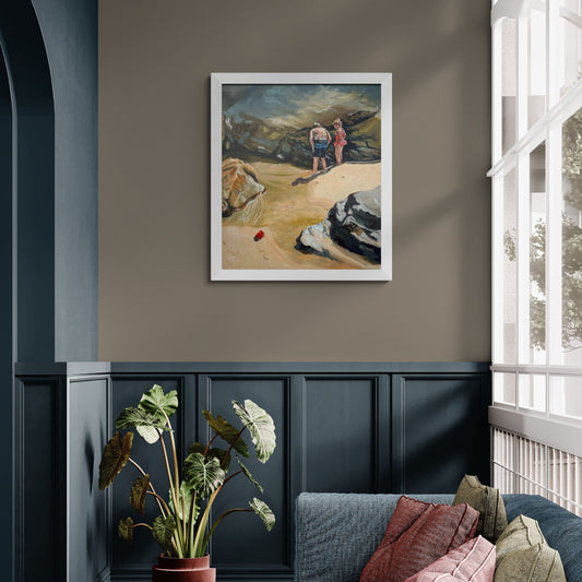 Framed seaside art of two young children exploring rockpools together. 