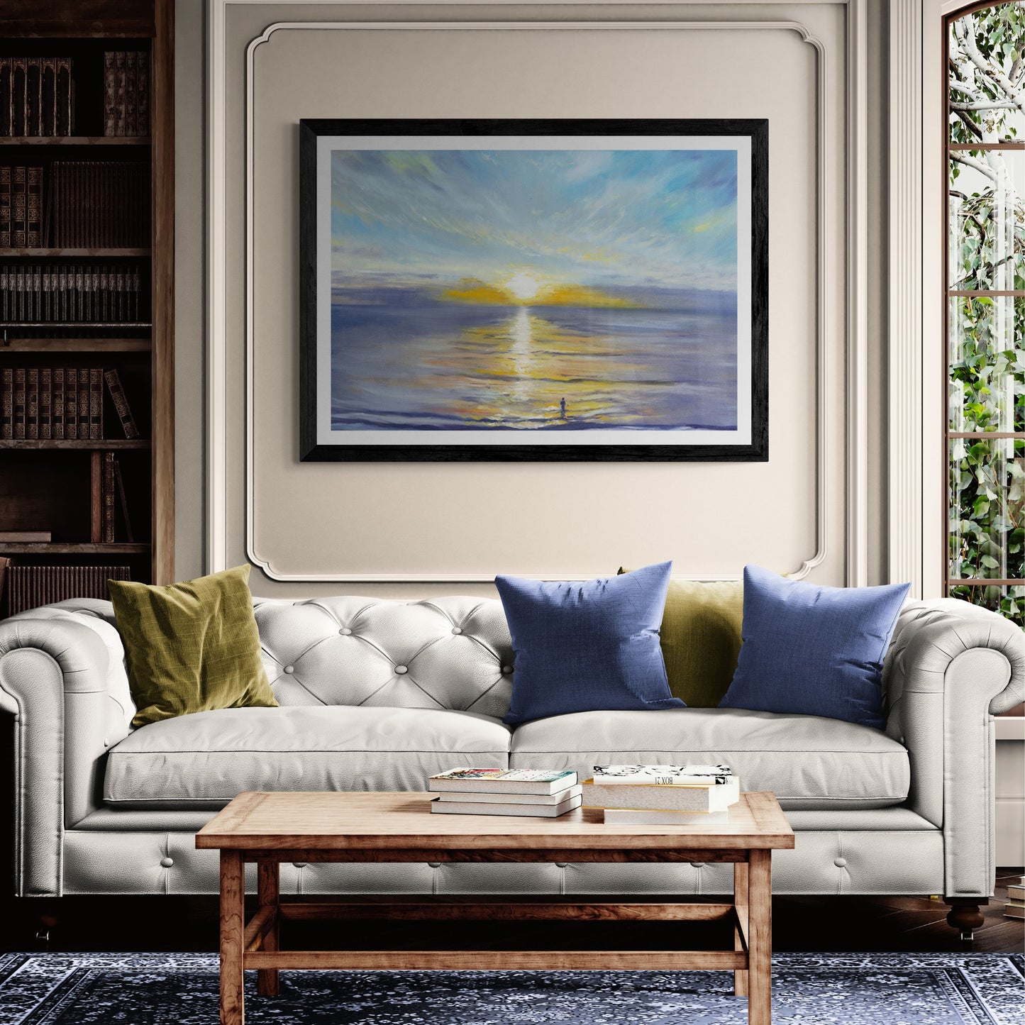 Living room with a grey sofa, wooden coffee table, and framed seascape artwork of a sunrise at Penzance seafront.