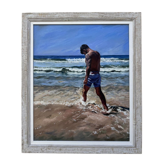 Framed original oil painting by Lorraine Field of a man walking along a beach with ocean waves.