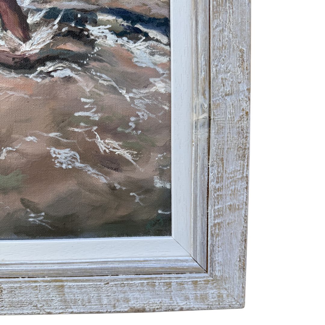 Close-up of a textured wooden frame with an original oil painting inside, showing beach surf.