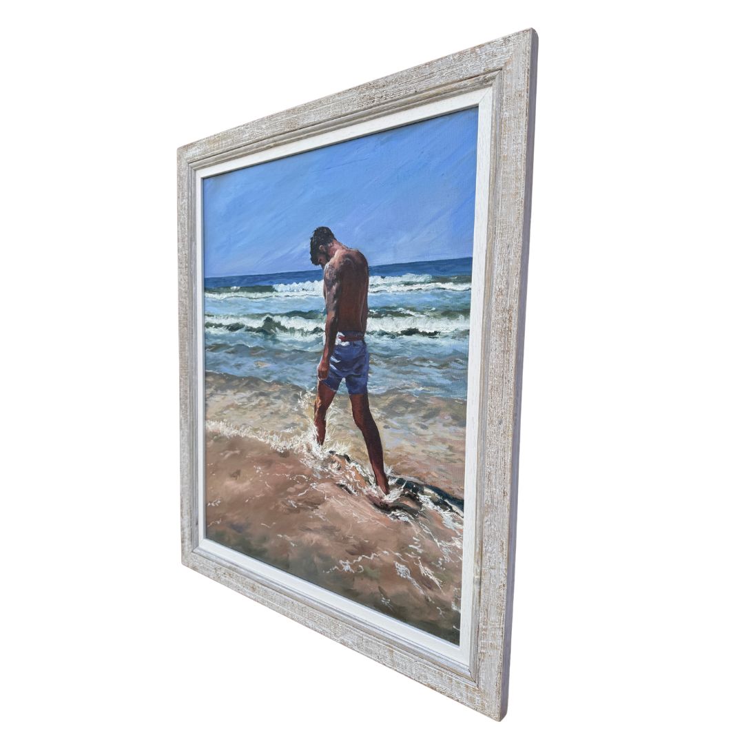 Right hand side of framed oil painting by Lorraine Field Art of a man walking through surf on a beach in Cornwall.