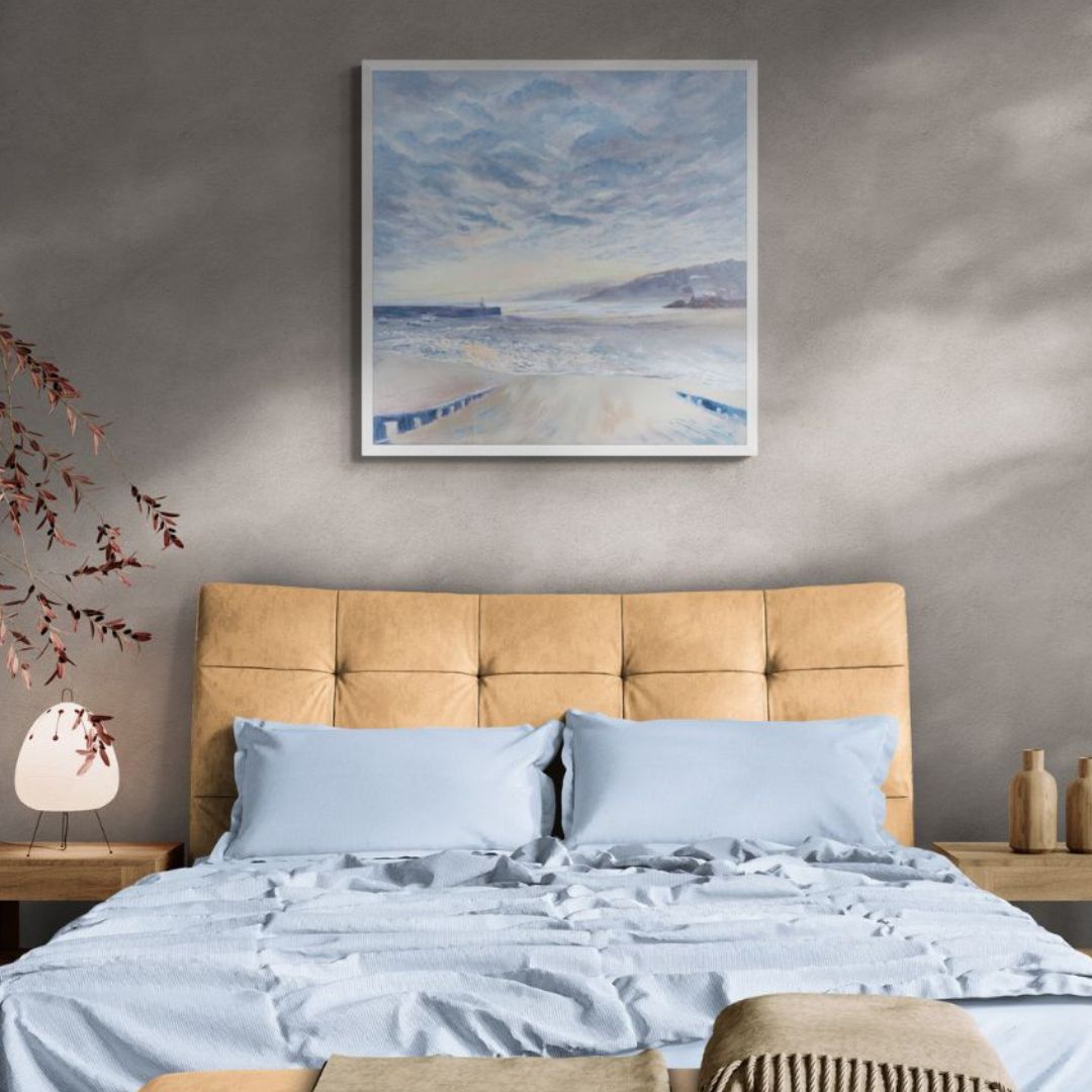 Fine art print for bedroom. Bed with beige headboard and light blue bedding.