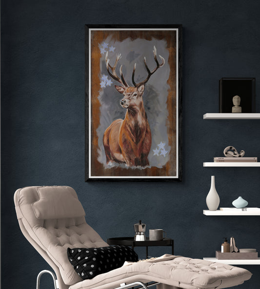 Stag fine art print in black frame displayed above recliner on dark grey wall