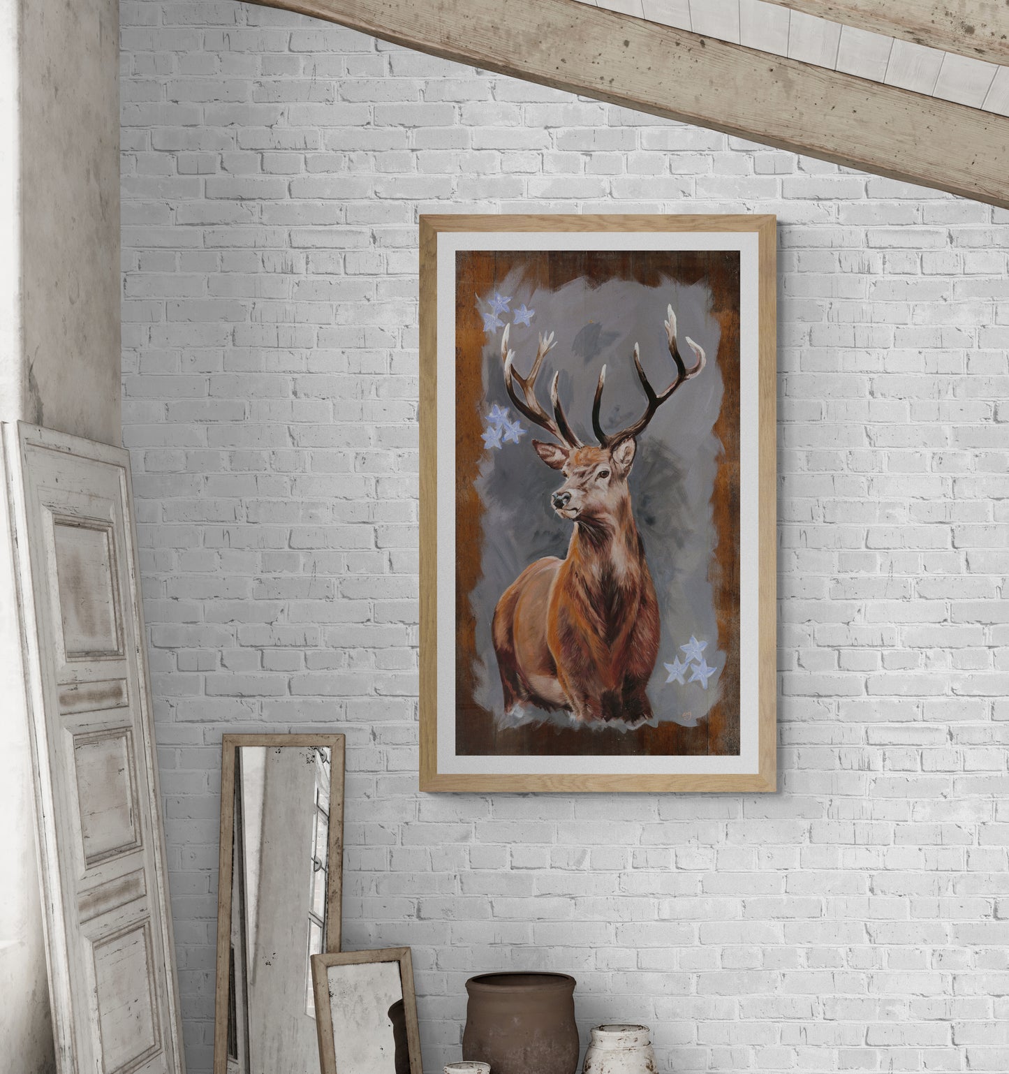 Stag fine art print in natural frame displaed on white brick wall in loft
