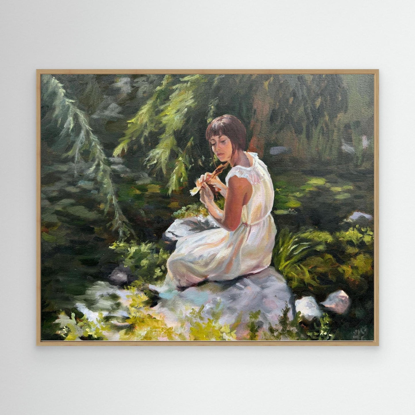 Stillness among the leaves lady sitting by a pond with lily pads - Canvas art print in oak frame option.