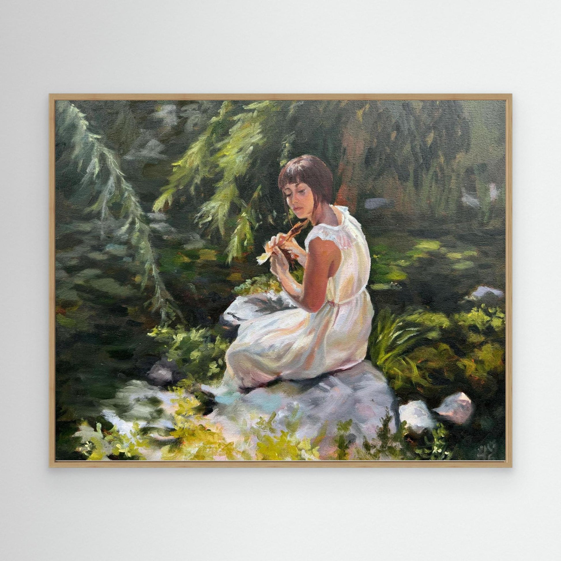 Stillness among the leaves lady sitting by a pond with lily pads - Canvas art print in oak frame option.