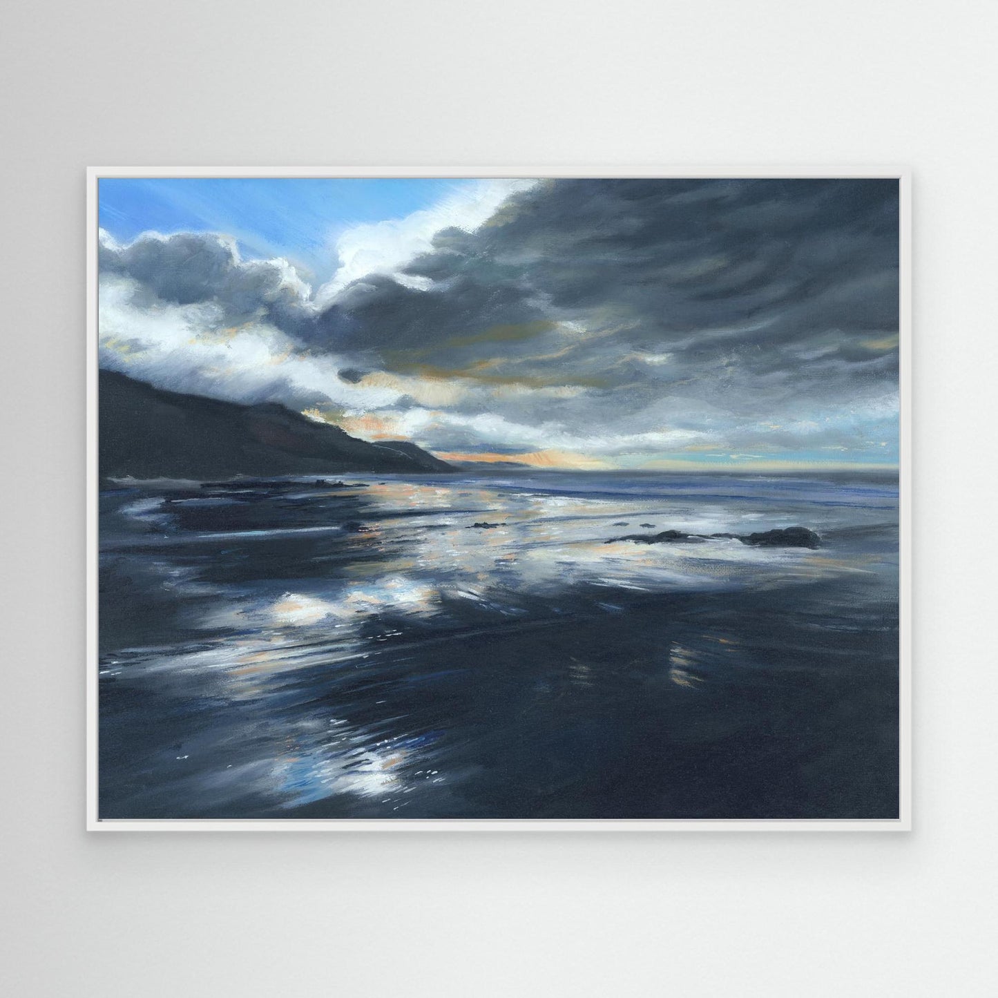 White framed coastal canvas print showing stormy skies over the sea with atmospheric blue and silver tones.