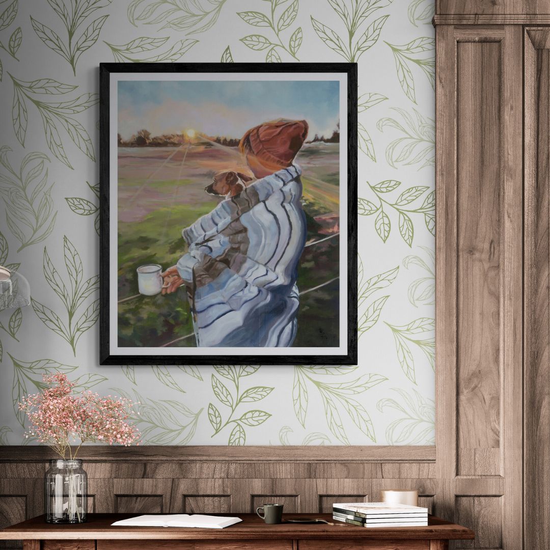 A woman and her dog fine art print framed in black frame with light green patterned wallpaper in the background