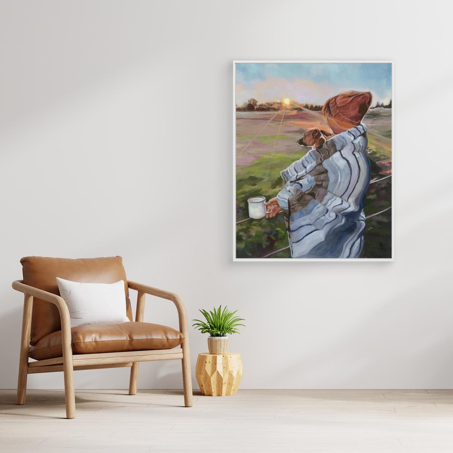 Painting of a person with a Jack Russell dog on a wall above a brown armchair in a room.