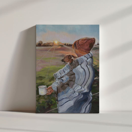 Unframed fine art print of a woman wrapped in a blanket with her dog, watching the sunrise while holding a mug. Soulful artwork by Lorraine Field Art.