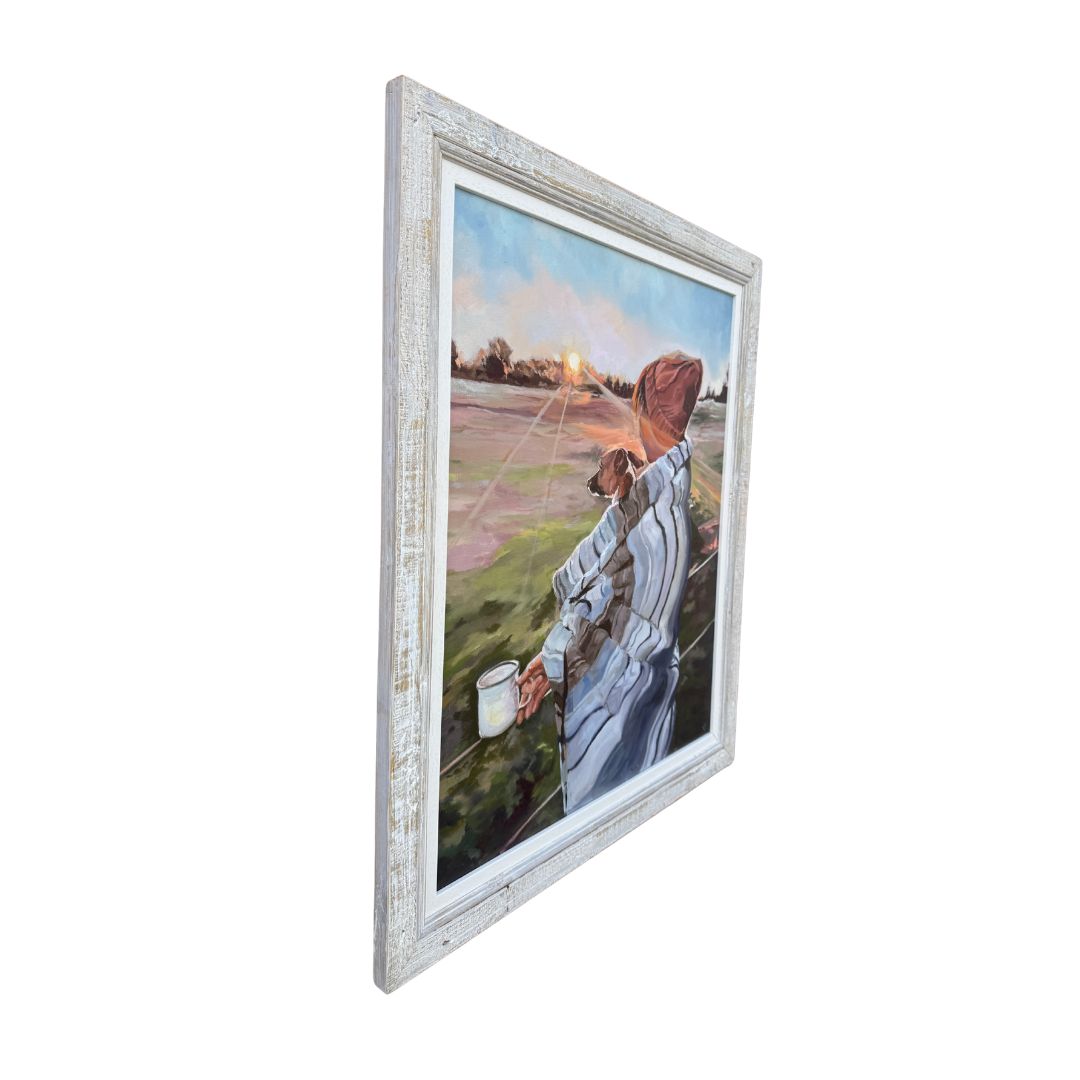 Left hand close up of framed original oil painting of a person with a Jack Russell dog watching the sun rise. 