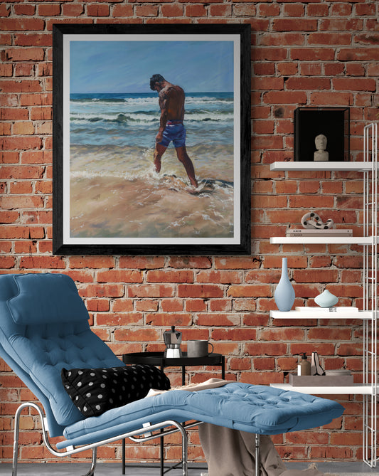 Surfer dude kicks the surf on a beach in Cornwall Fine art print with black frame