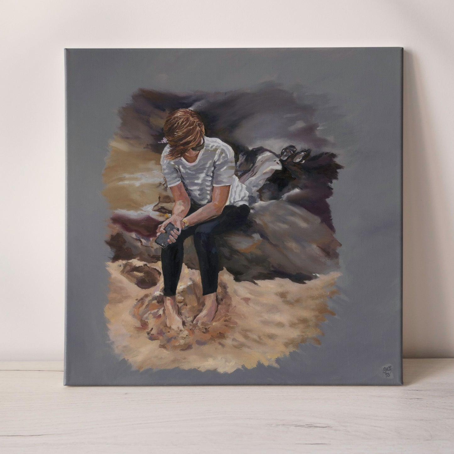 Oil painting of a beach scene of a young lady sitting on a rock with a neutral background