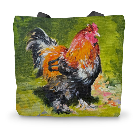 A tote bag featuring a colorful painting of a cockerel on a green background.